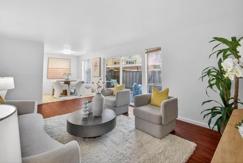 a living room with furniture and a potted plant