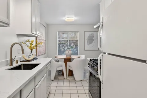 a kitchen with a sink appliances and cabinets