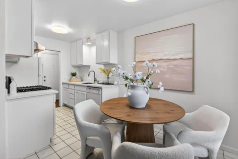 a dining room with furniture a window and kitchen view