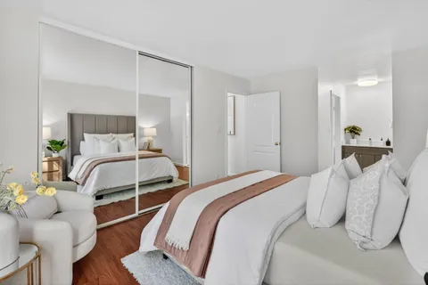 a bedroom with a bed and wooden floor