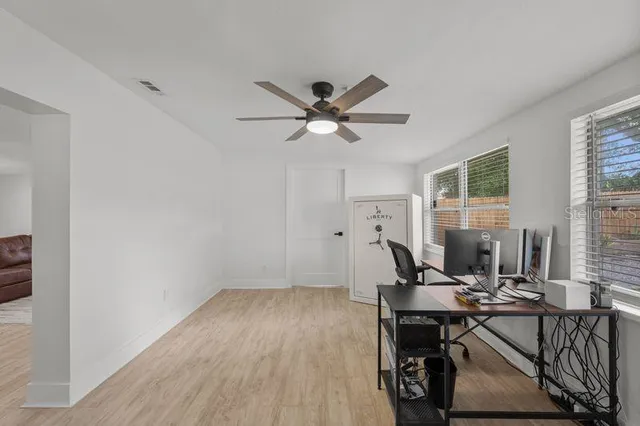 a view of a livingroom with workspace and a window
