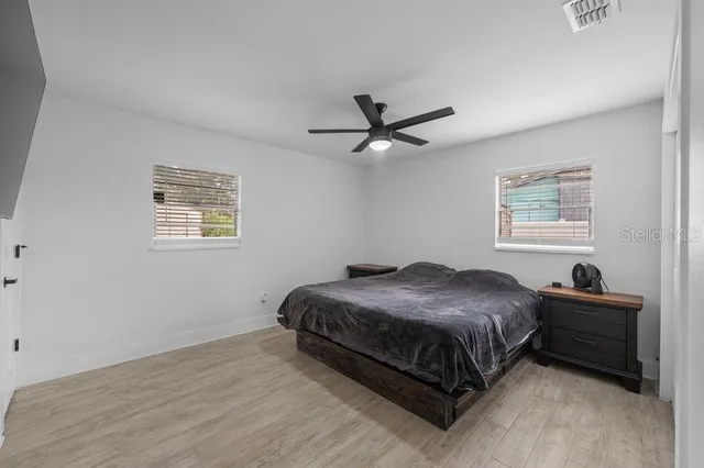 a bedroom with a bed and a chandelier