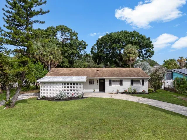 a front view of a house with a garden