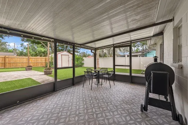 a view of a patio with a table chairs and a backyard