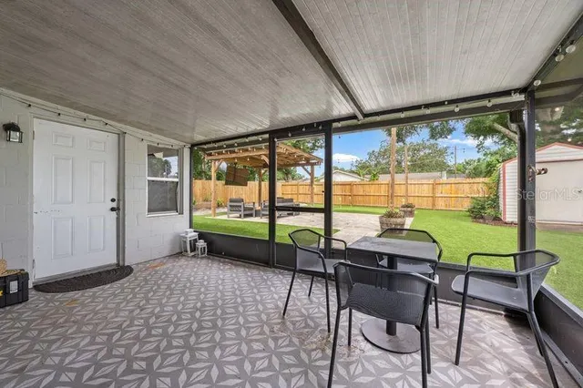 a view of a house with backyard and sitting area