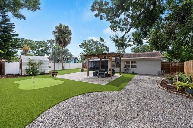 a swimming pool with outdoor seating and yard