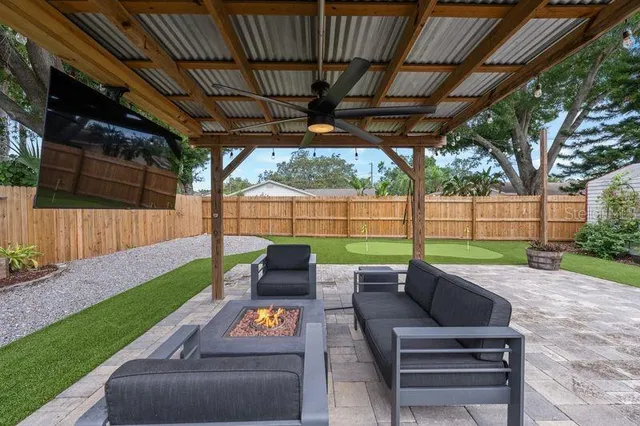 an aerial view of residential houses with outdoor space and trees