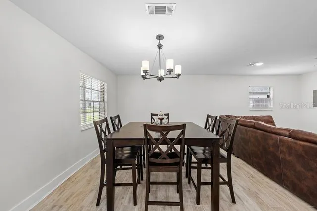 a view of a dining room with furniture window and wooden floor