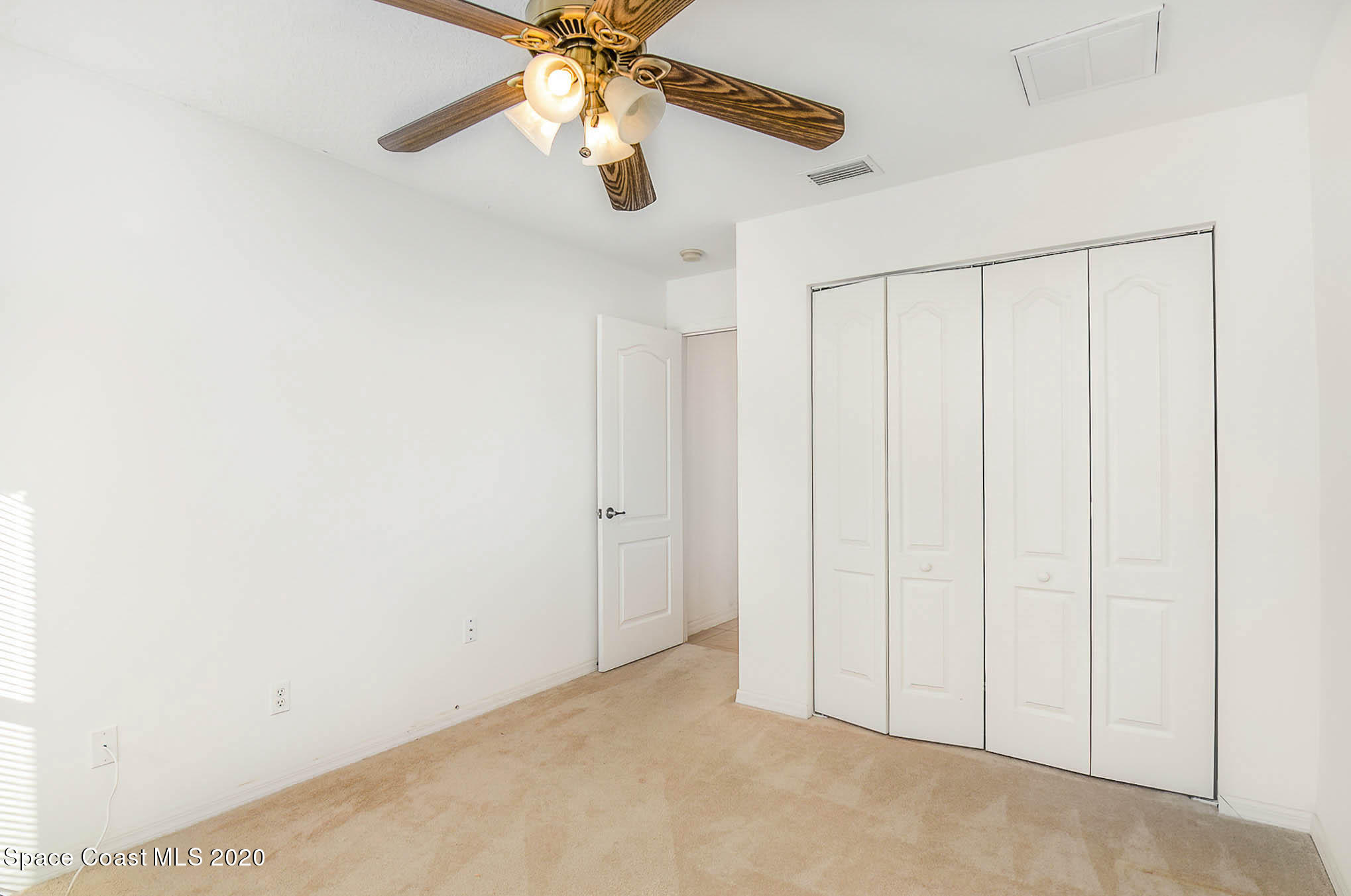 685 Hall Road Malabar, FL 32950 - Photo 14 of 35 an empty room with chandelier fan