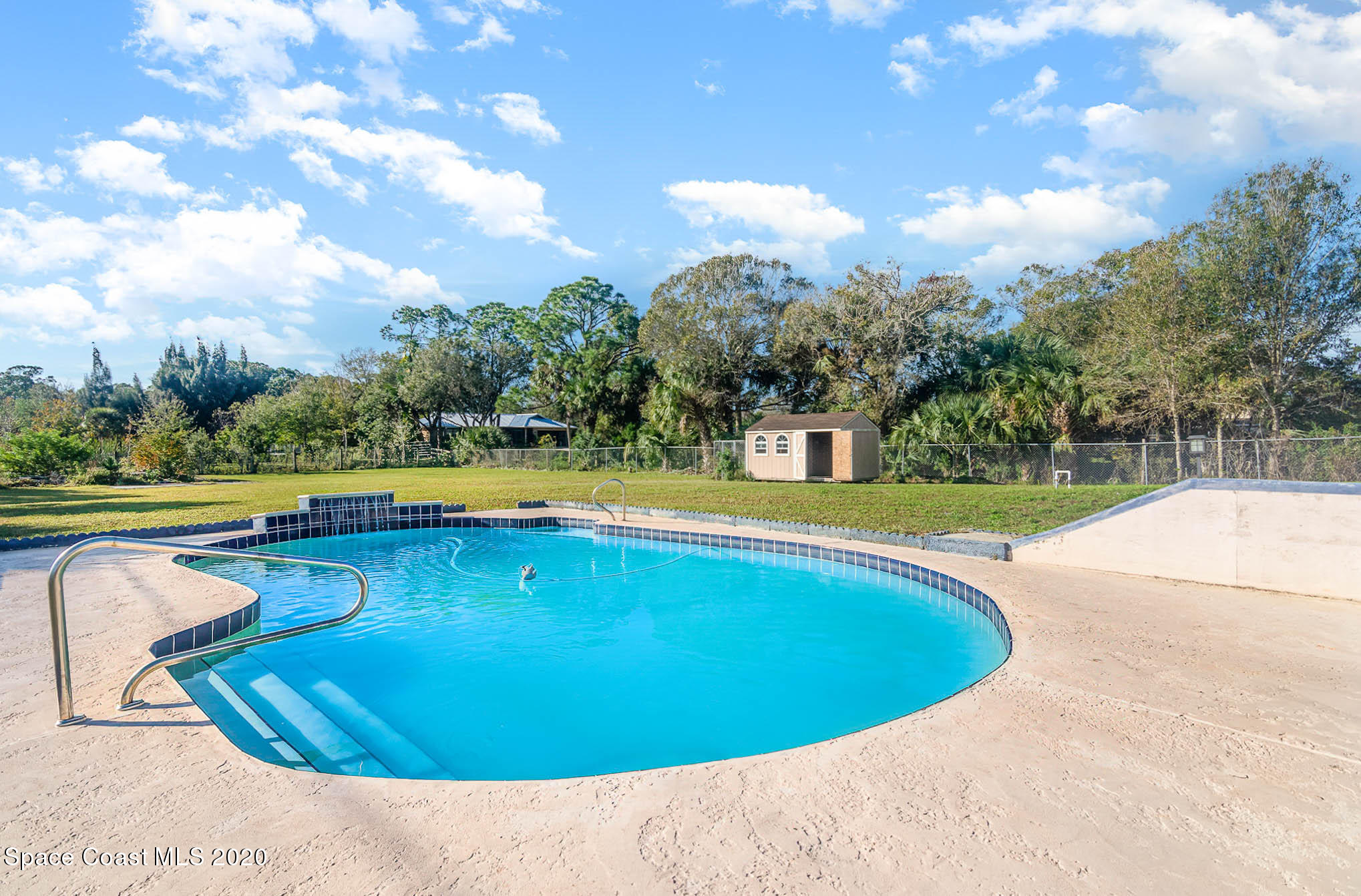 685 Hall Road Malabar, FL 32950 - Photo 22 of 35 a view of a swimming pool with a yard