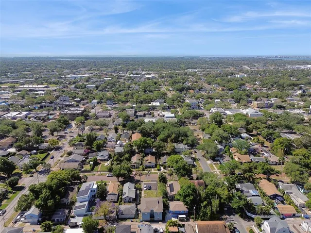 an aerial view of residential building with green space