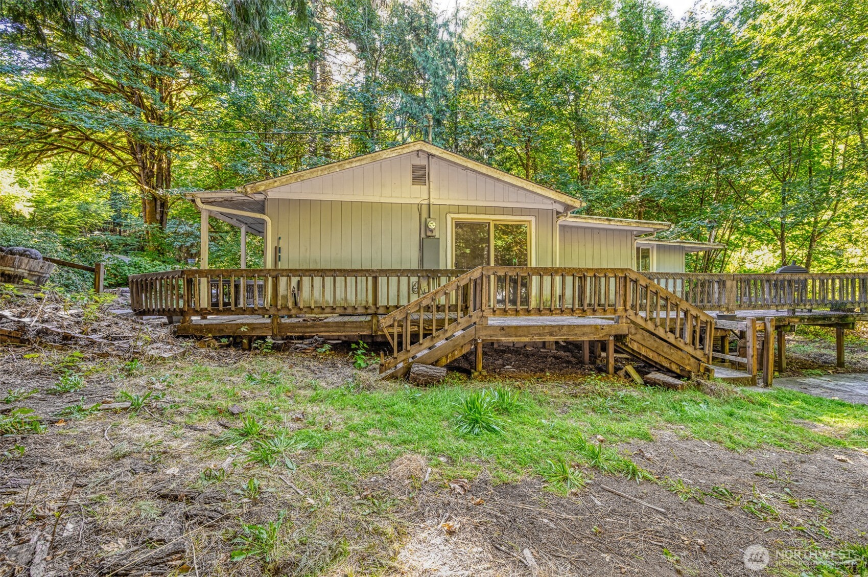 1671 Northeast Mission Creek Road Belfair, WA 98528 - Photo 18 of 31 a view of a house with a yard and a wooden deck