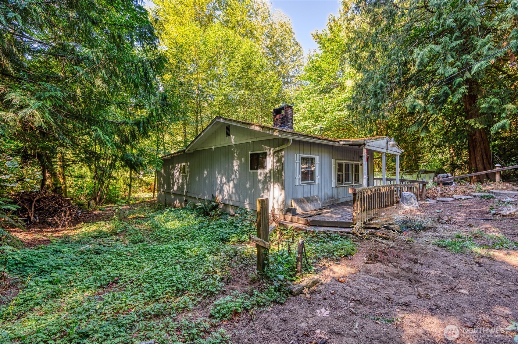 1671 Northeast Mission Creek Road Belfair, WA 98528 - Photo 21 of 31 a front view of house with a garden and trees