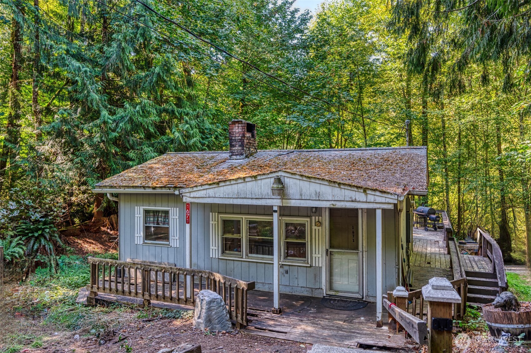 1671 Northeast Mission Creek Road Belfair, WA 98528 - Photo 3 of 31 a backyard of a house with table and chairs