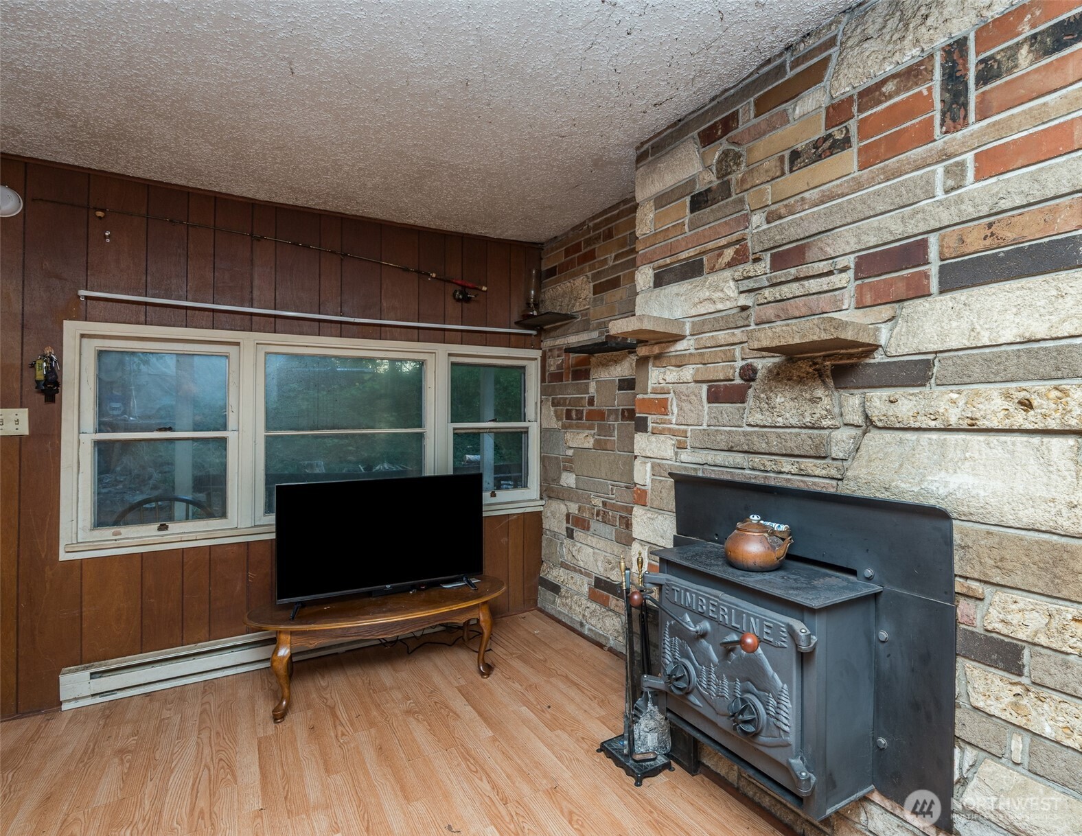1671 Northeast Mission Creek Road Belfair, WA 98528 - Photo 5 of 31 a living room with fireplace furniture and a floor to ceiling window