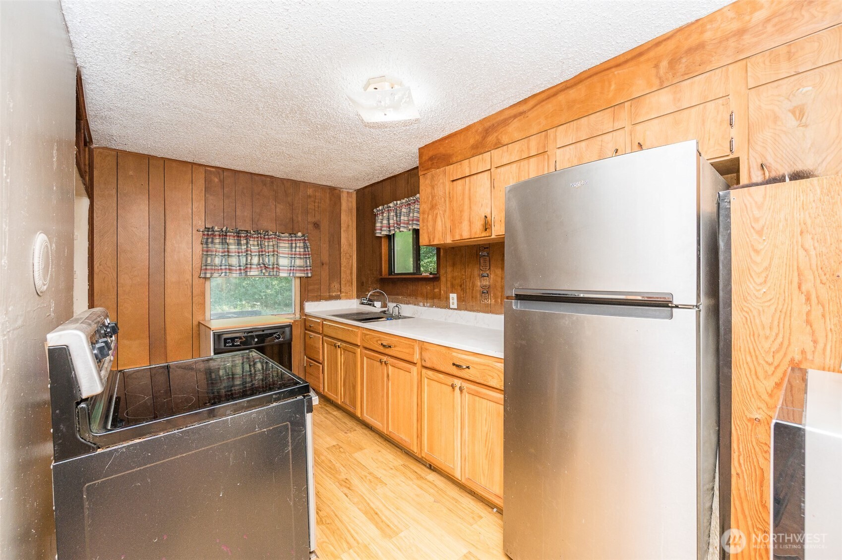 1671 Northeast Mission Creek Road Belfair, WA 98528 - Photo 10 of 31 a kitchen with stainless steel appliances granite countertop a refrigerator and a stove