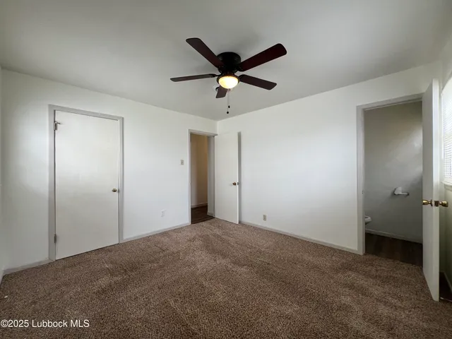 a view of a livingroom with a ceiling fan and a ceiling fan