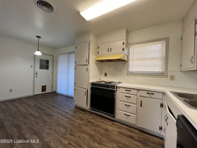 a kitchen with granite countertop a stove and a sink