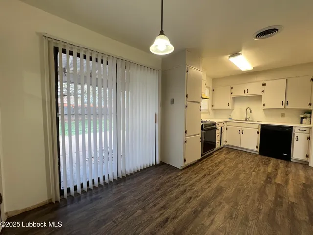 a view of a kitchen with a sink and dishwasher