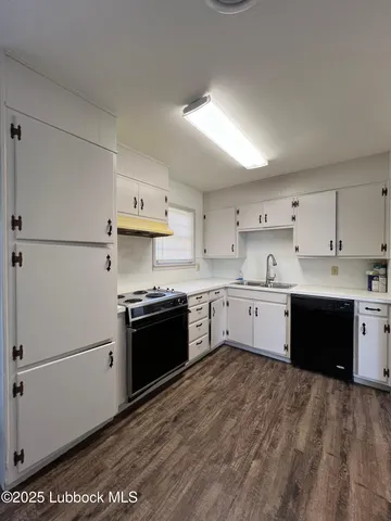 a kitchen with a stove top oven sink and cabinets