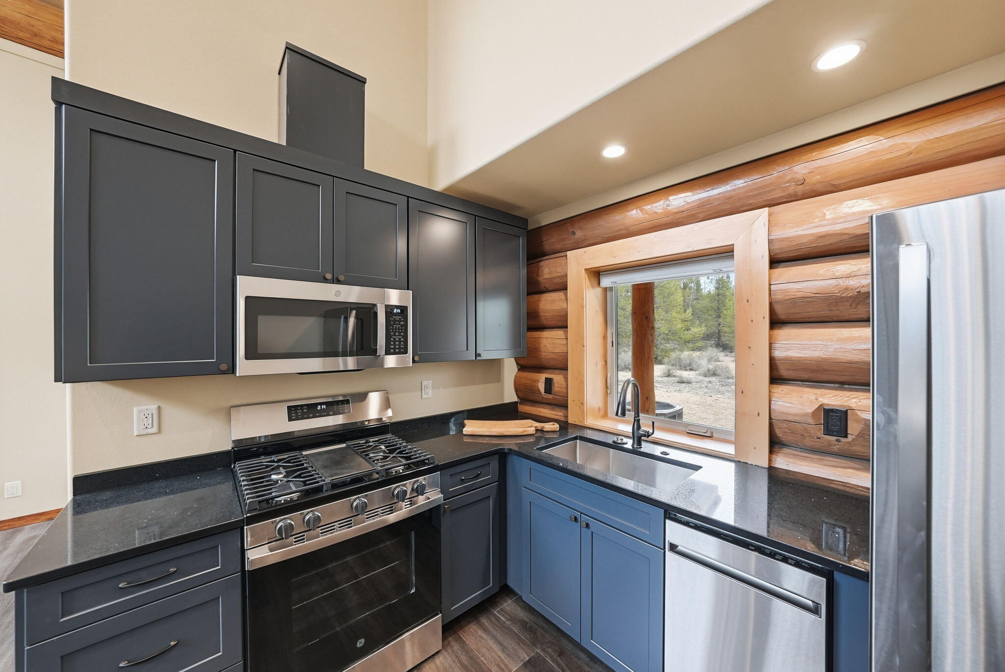 54270 Huntington Road La Pine, OR 97739 - Photo 11 of 68 a kitchen with stainless steel appliances granite countertop a stove microwave and refrigerator