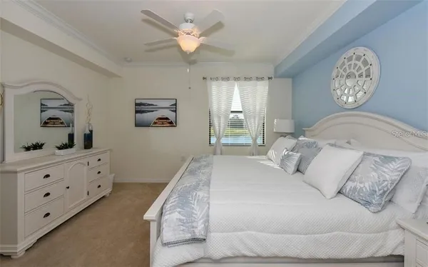 a bedroom with a bed and a painting on the wall