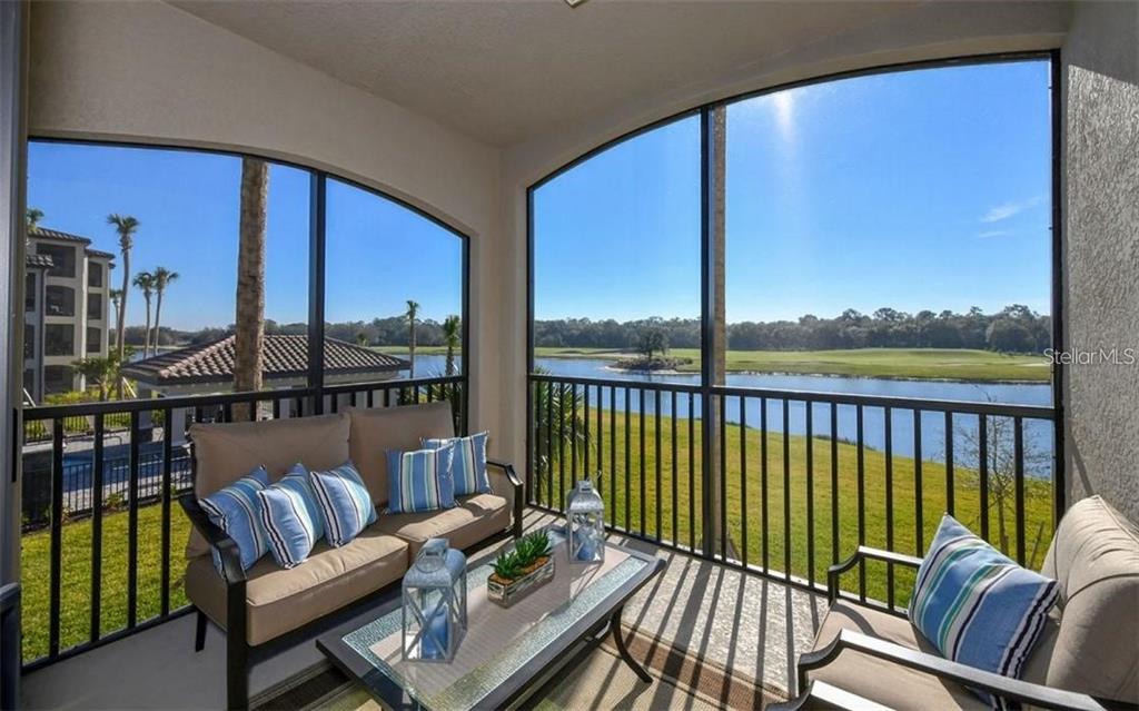 16904 Vardon Terrace, Unit 201 Lakewood Ranch, FL 34211 - Photo 22 of 35 a balcony with wooden floor view