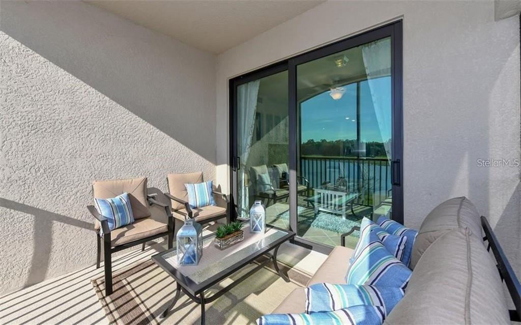 16904 Vardon Terrace, Unit 201 Lakewood Ranch, FL 34211 - Photo 23 of 35 a living room with furniture and a large window