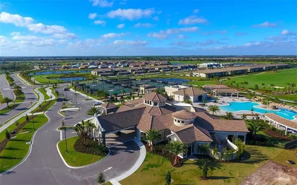 an aerial view of residential houses with outdoor space and lake view