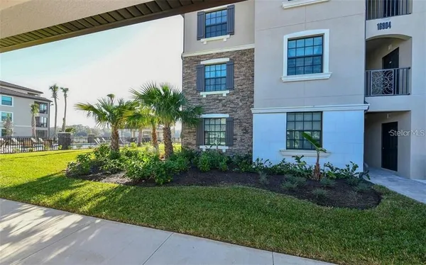a view of a house with a yard and plants