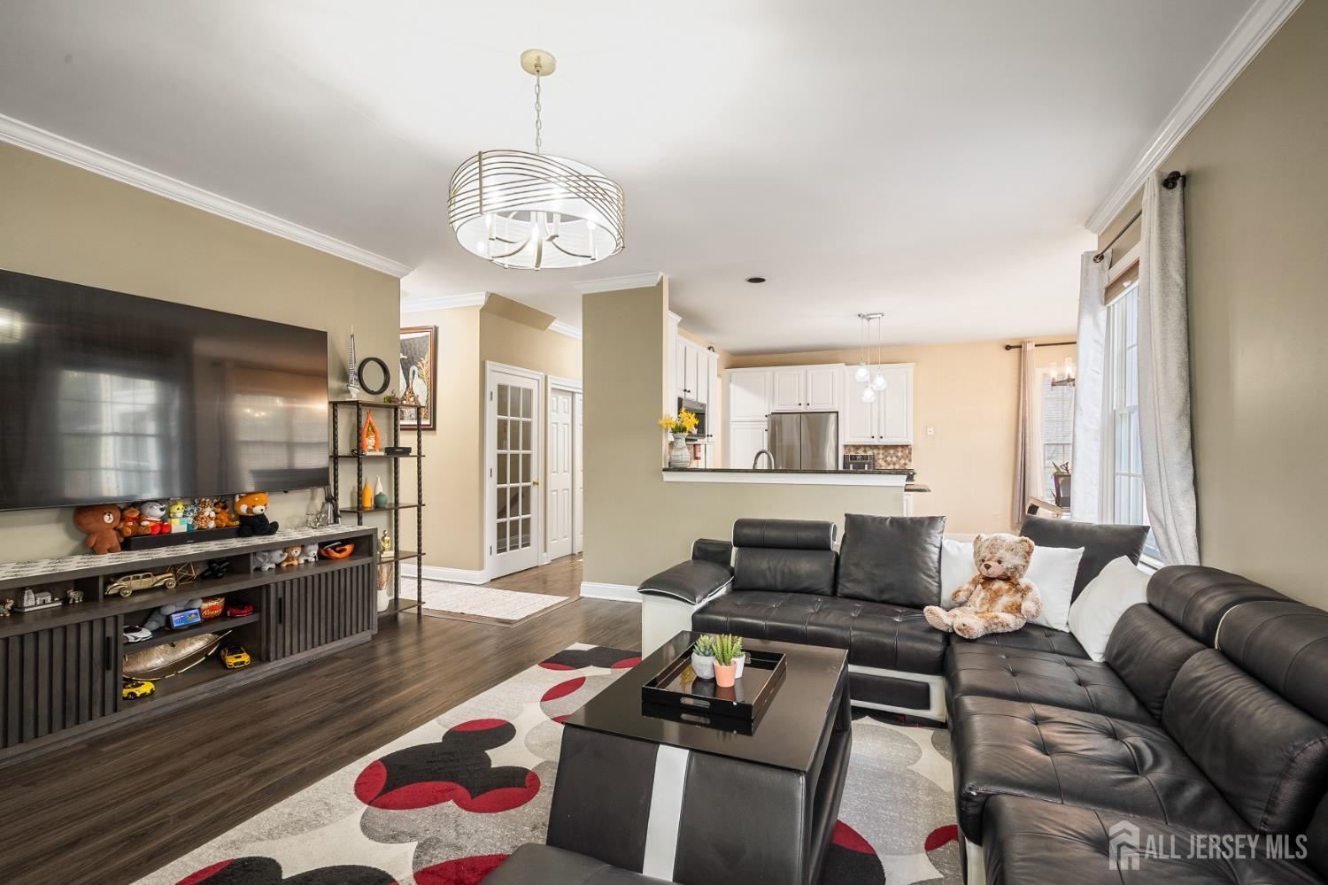3 Milburne Lane Robbinsville, NJ 08691 - Photo 24 of 50 a living room with furniture a flat screen tv and kitchen view