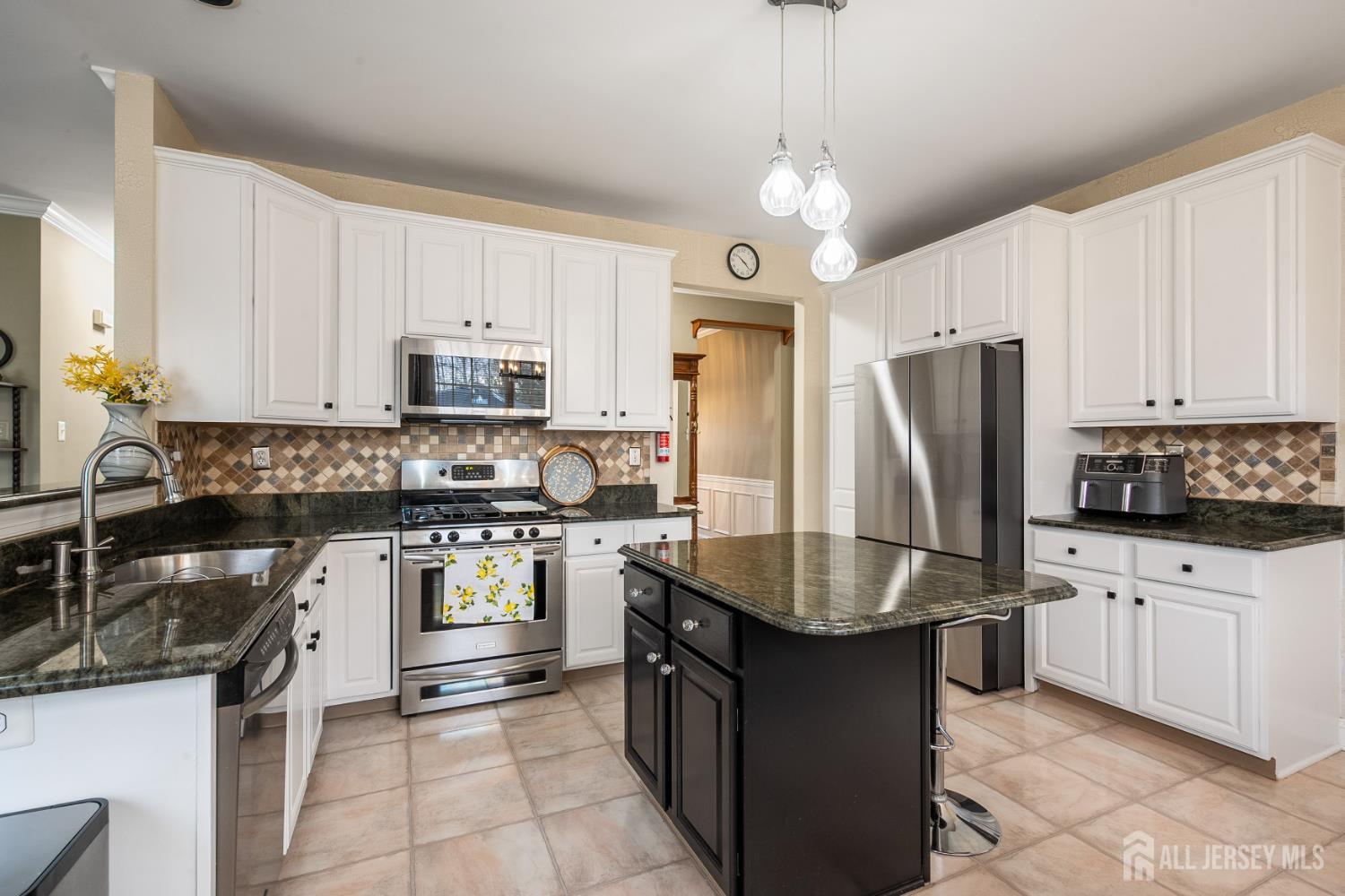 3 Milburne Lane Robbinsville, NJ 08691 - Photo 27 of 50 a kitchen with stainless steel appliances granite countertop a refrigerator a stove a sink a microwave and island