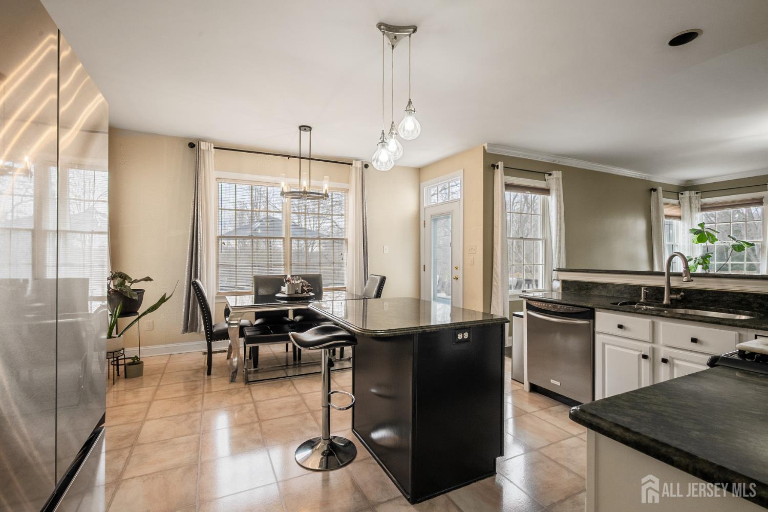 3 Milburne Lane Robbinsville, NJ 08691 - Photo 28 of 50 a kitchen with a table chairs stove and cabinets