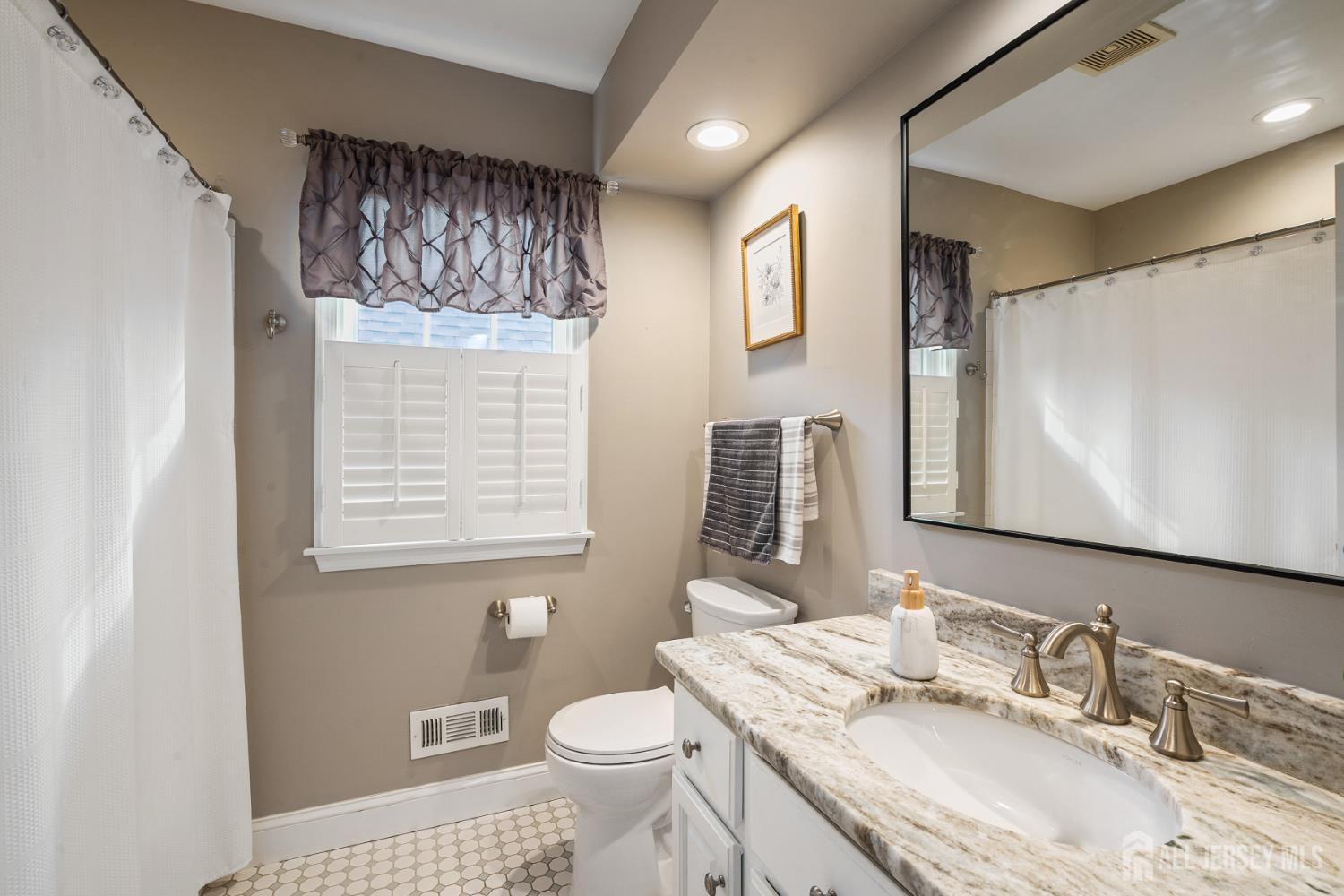 3 Milburne Lane Robbinsville, NJ 08691 - Photo 36 of 50 a bathroom with a granite countertop sink toilet and mirror