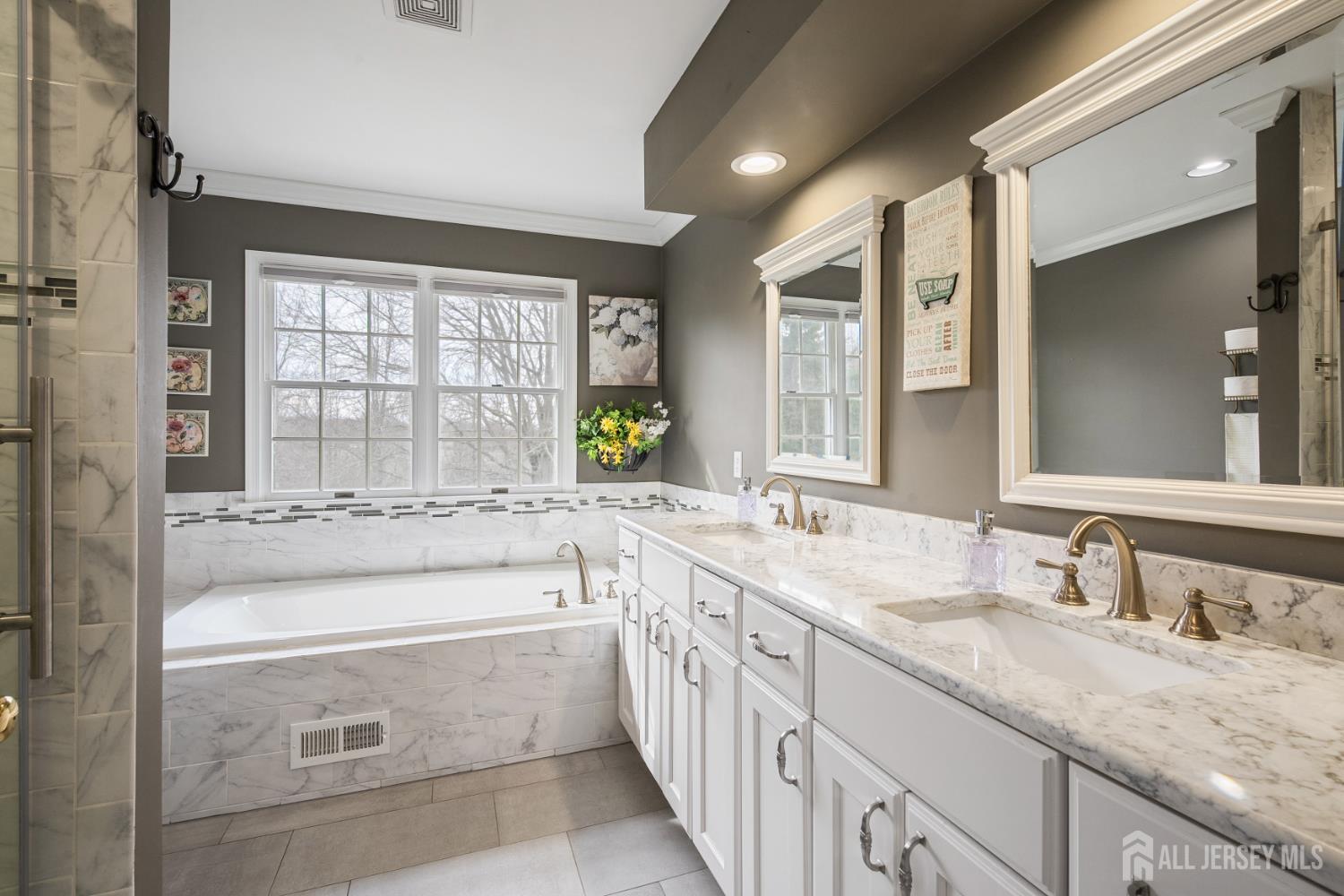 3 Milburne Lane Robbinsville, NJ 08691 - Photo 43 of 50 a bathroom with a granite countertop sink mirror and a bathtub
