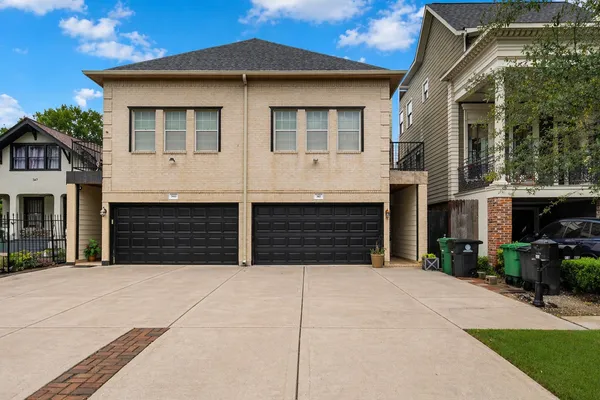 a front view of a house with garage and yard