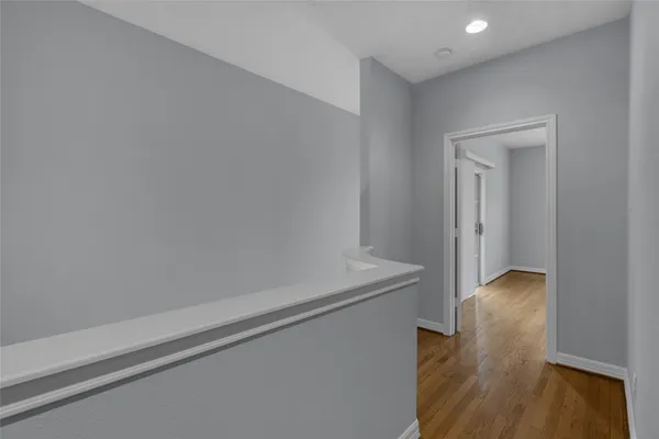 a view of hallway with wooden floor