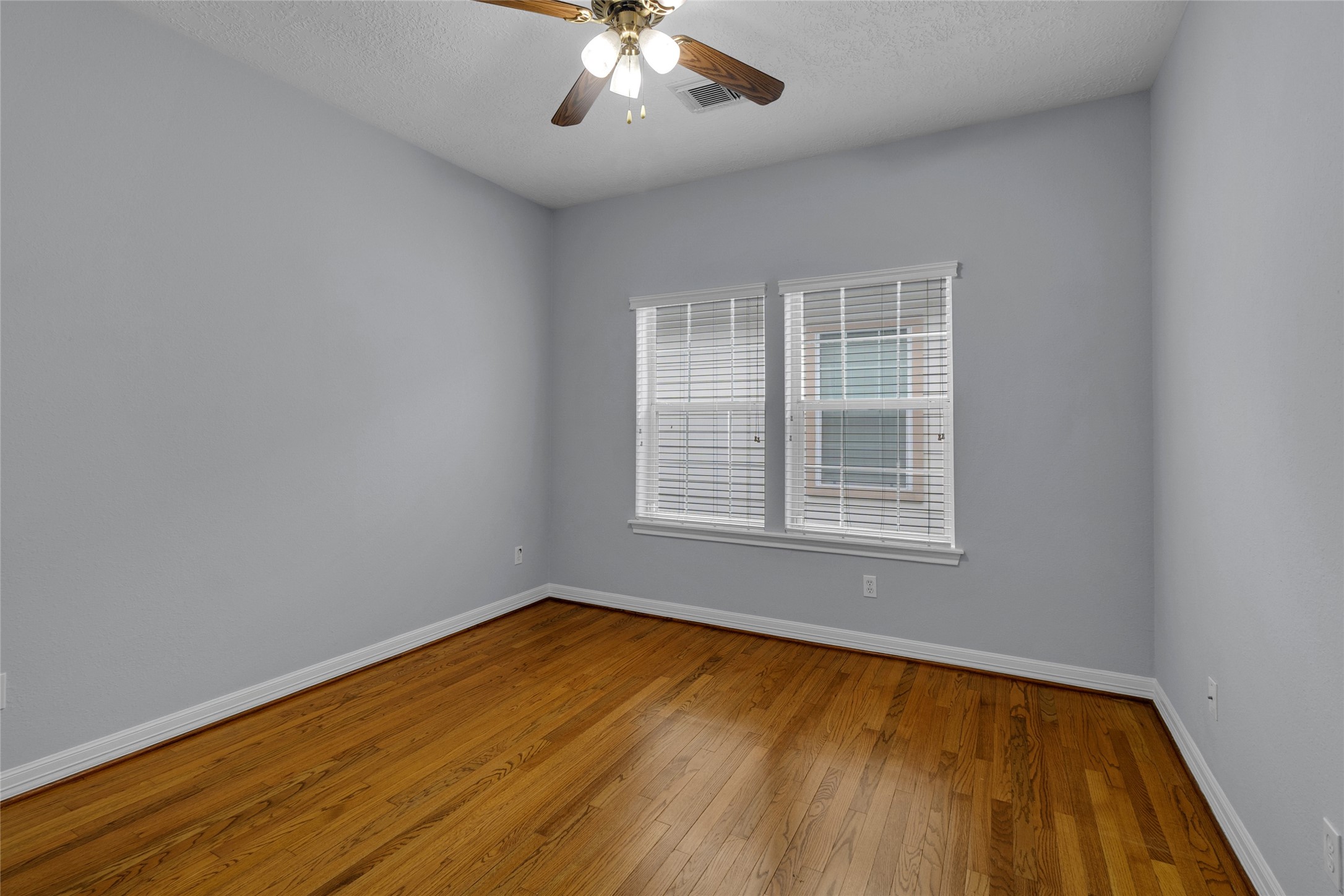 341 West 23rd Street Houston, TX 77008 - Photo 17 of 26 a view of an empty room with wooden floor and a window