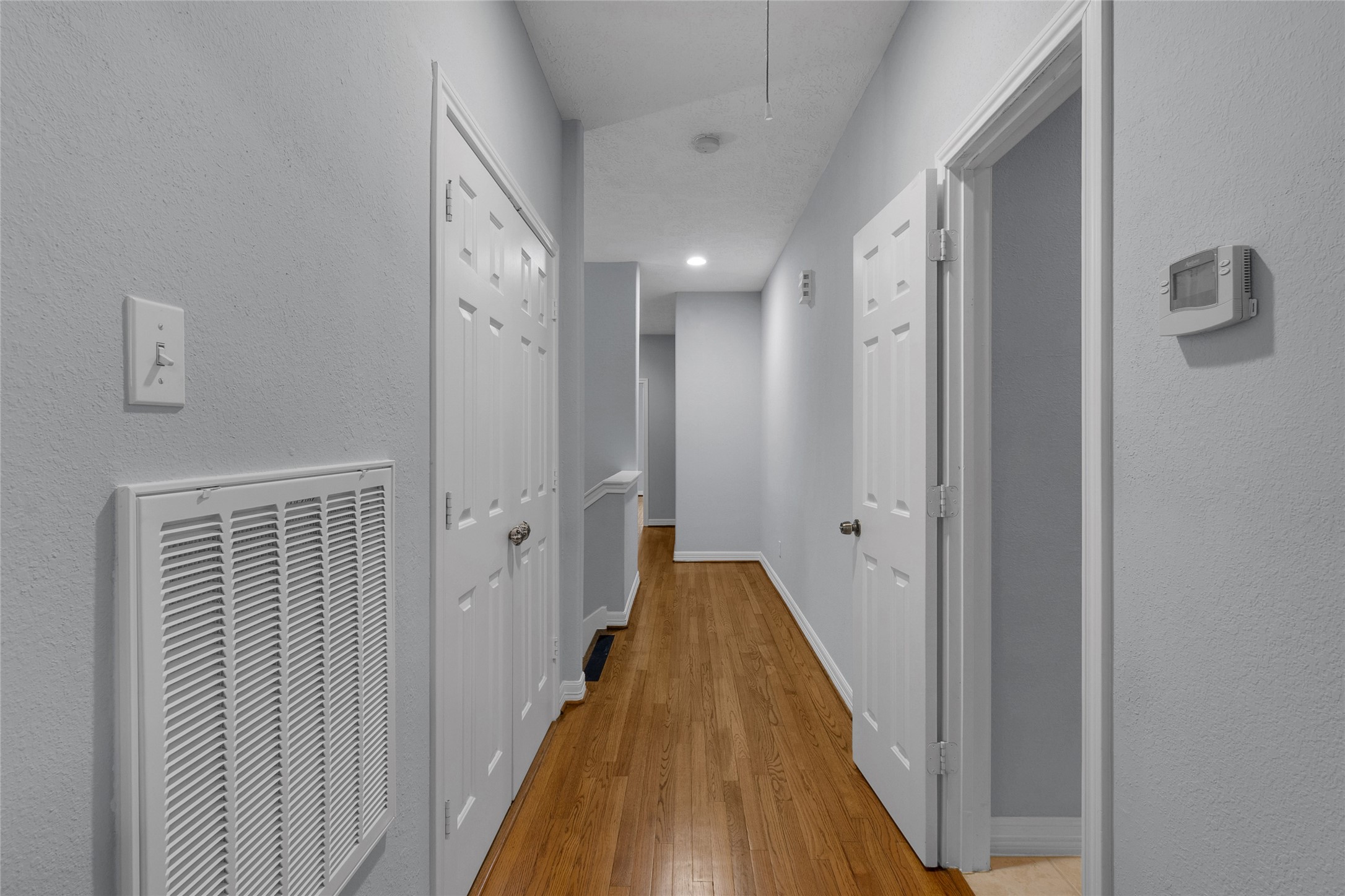341 West 23rd Street Houston, TX 77008 - Photo 4 of 26 a view of a hallway with wooden floor and staircase
