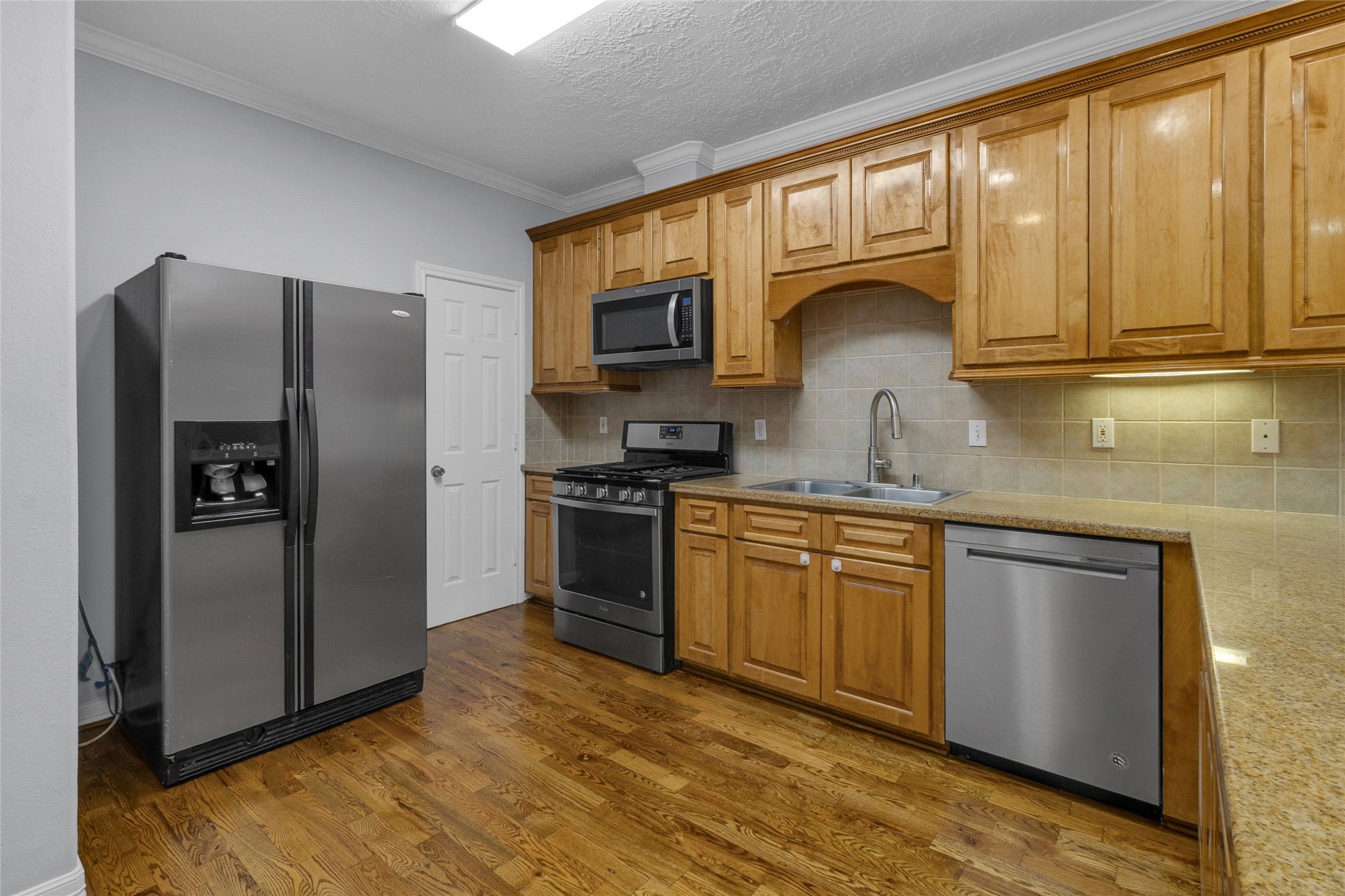341 West 23rd Street Houston, TX 77008 - Photo 5 of 26 a kitchen with stainless steel appliances granite countertop a refrigerator sink and stove