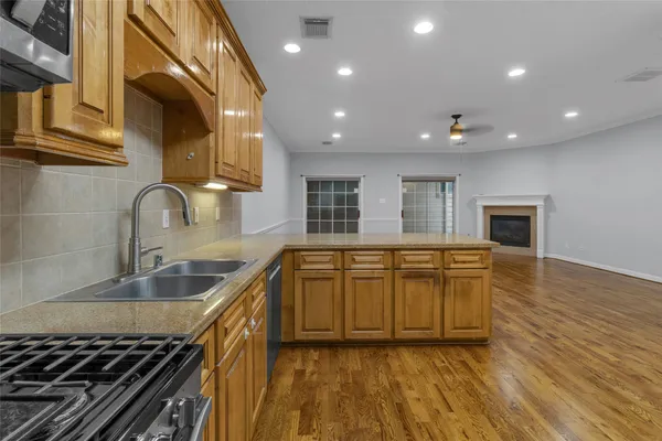 a kitchen with stainless steel appliances granite countertop a sink and a stove