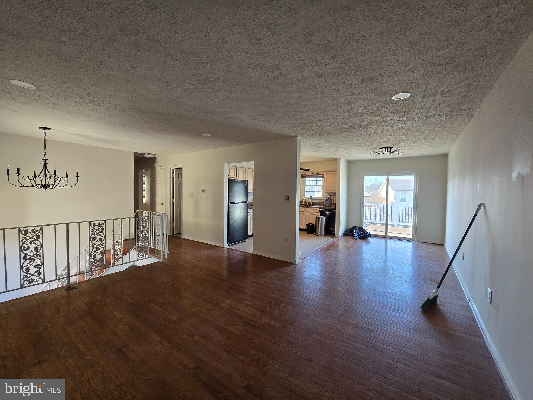 8907 Chad Way Clinton, MD 20735 - Photo 11 of 48 a view of an empty room with wooden floor and a window