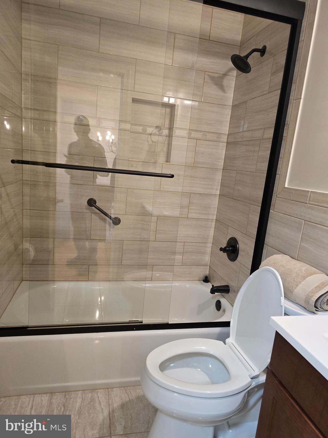 8907 Chad Way Clinton, MD 20735 - Photo 23 of 48 a white toilet sitting next to a bath tub and shower