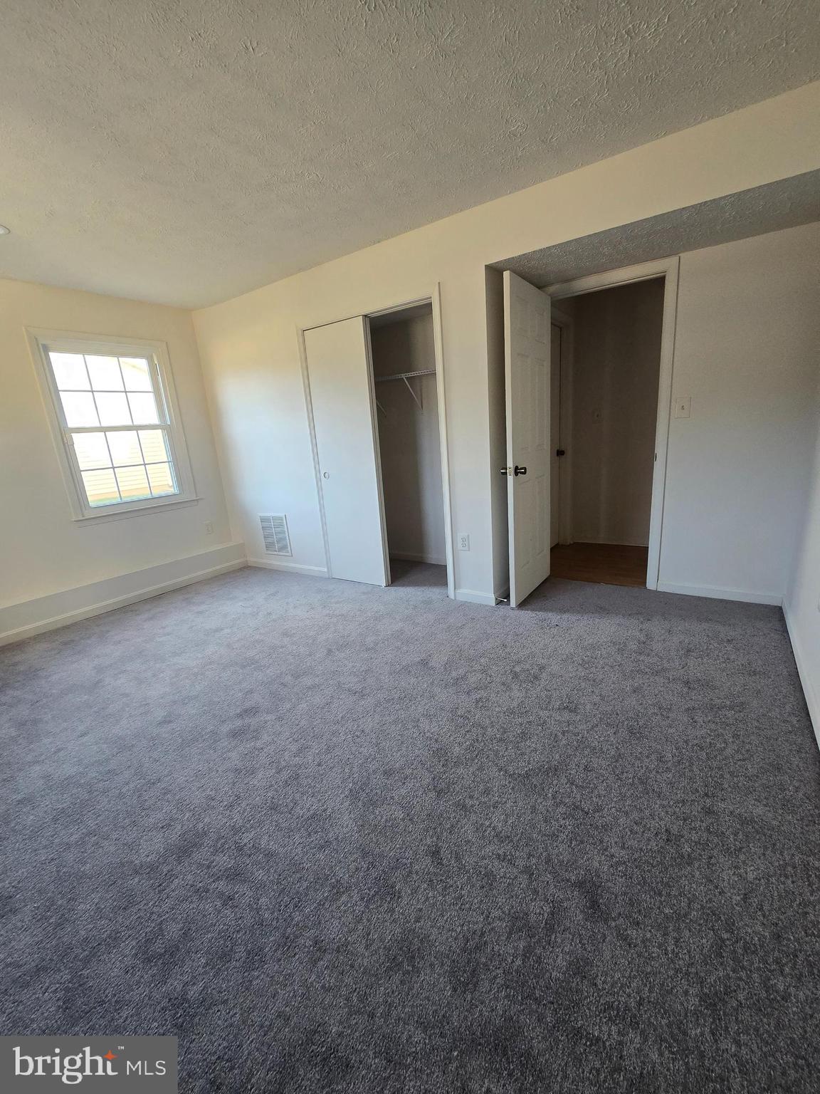 8907 Chad Way Clinton, MD 20735 - Photo 9 of 48 a view of empty room with windows