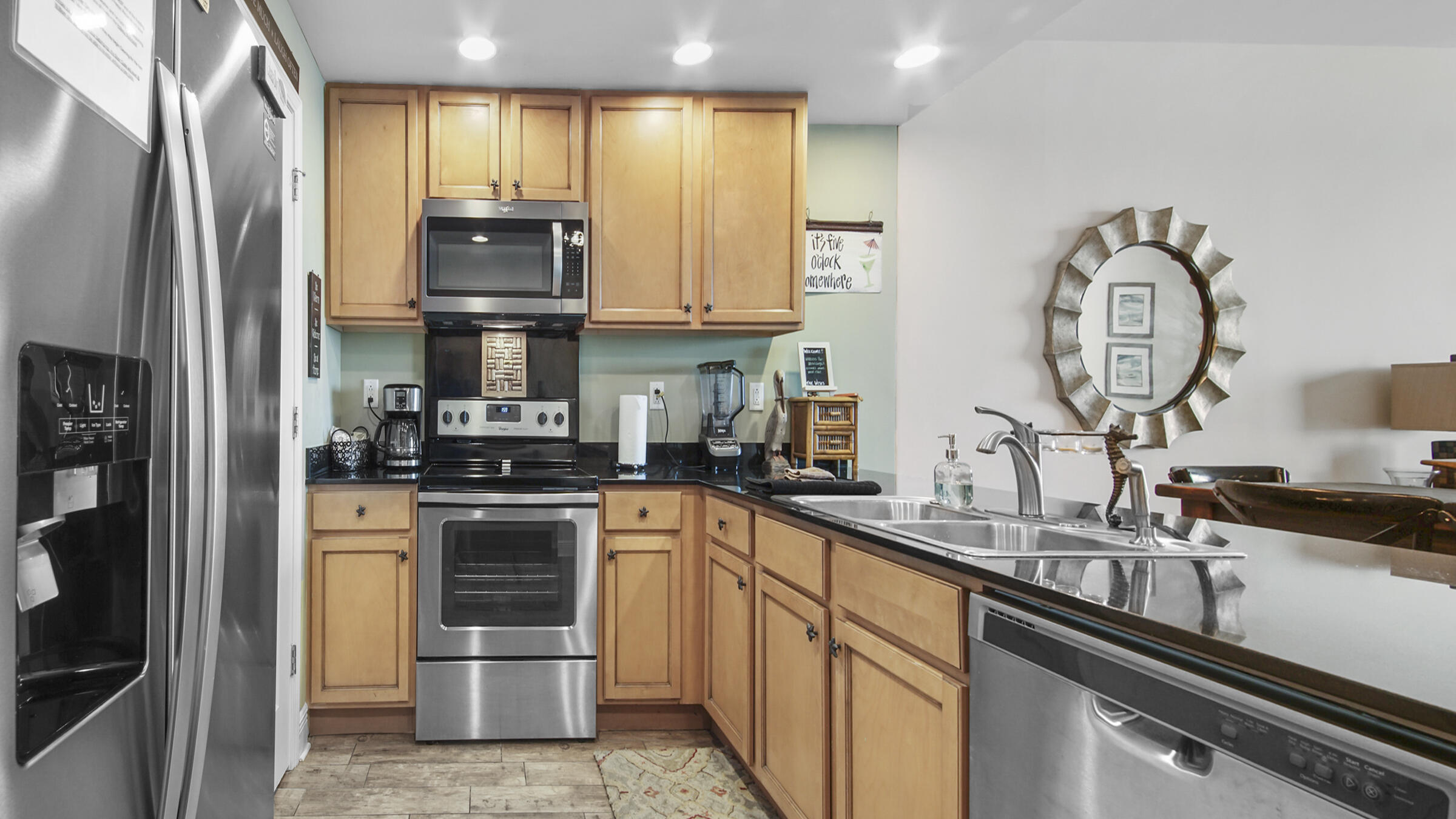 16701 Front Beach Road, Unit 1502 Panama City Beach, FL 32413 - Photo 18 of 33 a kitchen with a sink cabinets and stainless steel appliances