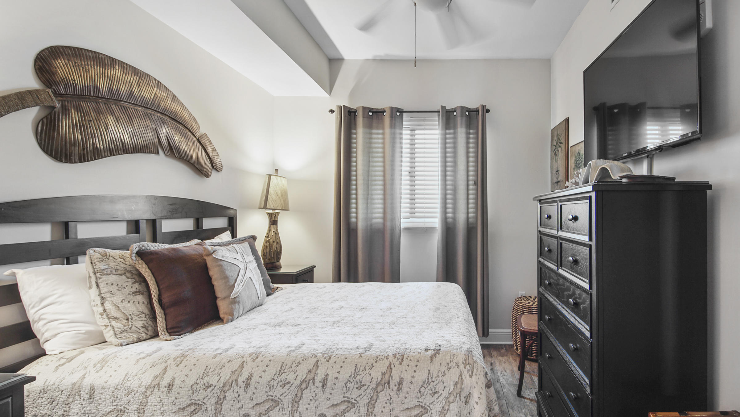 16701 Front Beach Road, Unit 1502 Panama City Beach, FL 32413 - Photo 21 of 33 a bedroom with a large bed and a flat tv screen