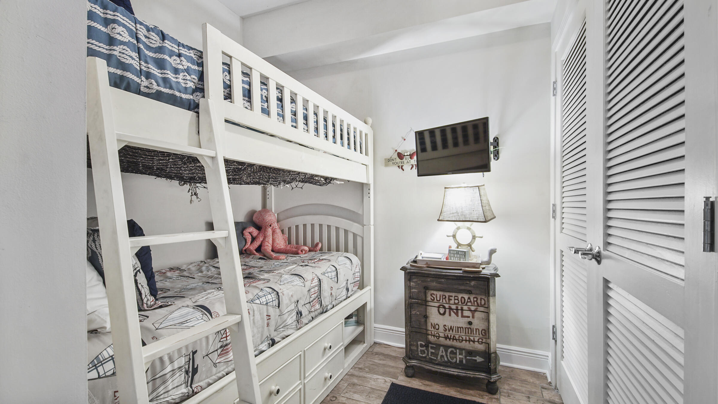 16701 Front Beach Road, Unit 1502 Panama City Beach, FL 32413 - Photo 25 of 33 a bedroom with a bed and a tv