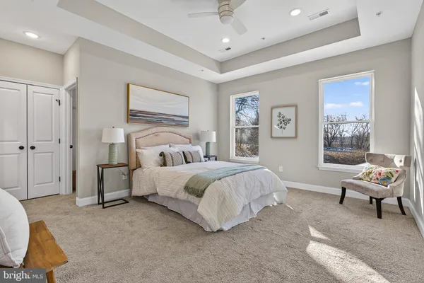 a spacious bedroom with a bed and a window
