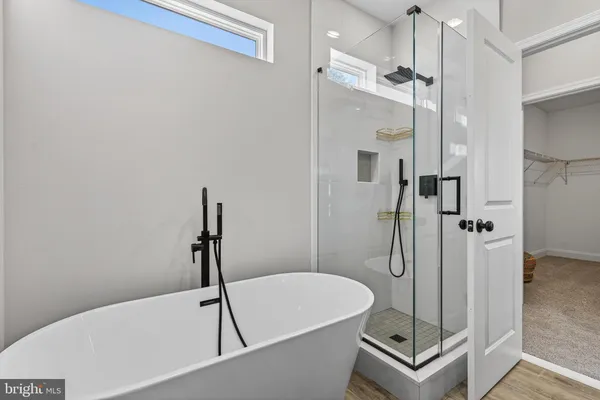 a bathroom with a bathtub and a shower