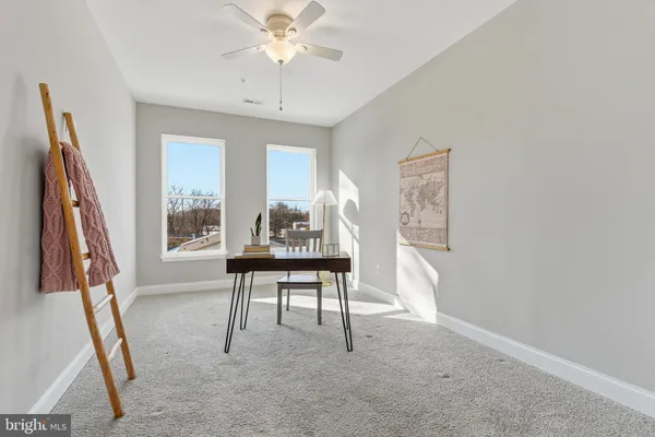 a view of a livingroom with furniture window and wooden floor